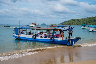 A Paradise island, tropical beach, emerald green sea with beach trees and blue sky background, Indonesia, south asia. Local people have a simple life like fishermen and sellers. Indonesia, South Asia