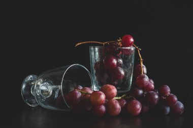 Red grapes, large bunch of fruits, fresh and tasty simple food on a dark background in a fancy minimal composition