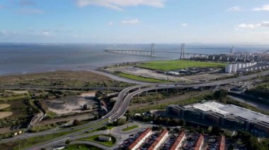 Aerial view of countryside around the Vasco da Gama bridge in Lisbon, with the view of highways and Tagus river. Top view of the longest bridge in Europe.