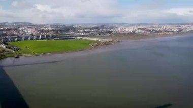 Aerial view of countryside around the Vasco da Gama bridge in Lisbon, with the view of highways and Tagus river. Top view of the longest bridge in Europe.