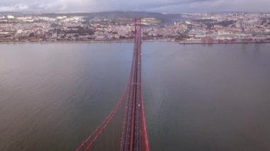 Aerial Drone view of the 25 De April Bridge. Red bridge in Lisbon, Portugal. Tagus River