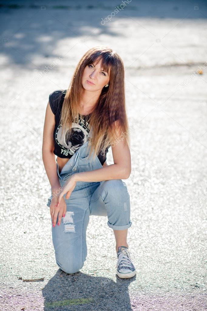 Beautiful girl in denim overalls — Stock Photo © Bajneva 88083604