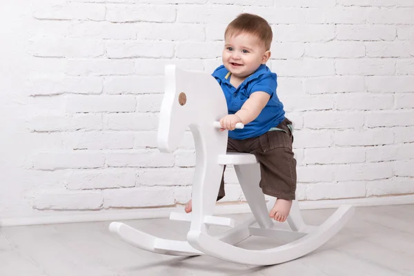 Baby sitting on the toy horse — Stock Photo, Image