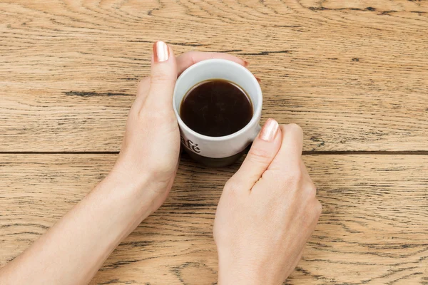 Coffee cup in female hands — Stock Photo, Image