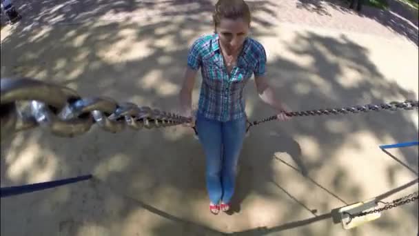 Young happy woman riding on a swing — Stock Video