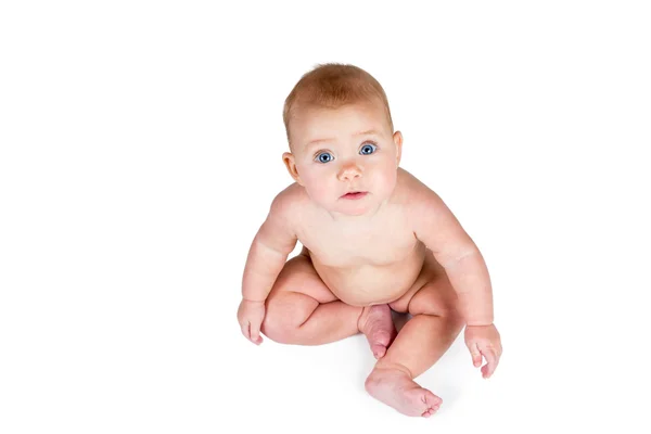 Naked baby sitting and looking up at the camera — Stock Photo, Image