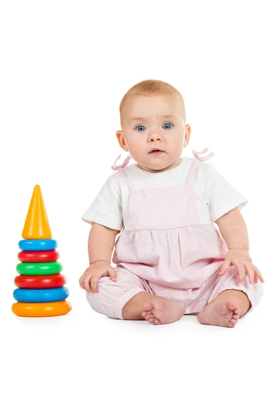 Baby sitting next to a pyramid — Stock Photo, Image