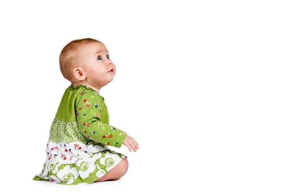 Baby sitting and looking to the side — Stock Photo, Image