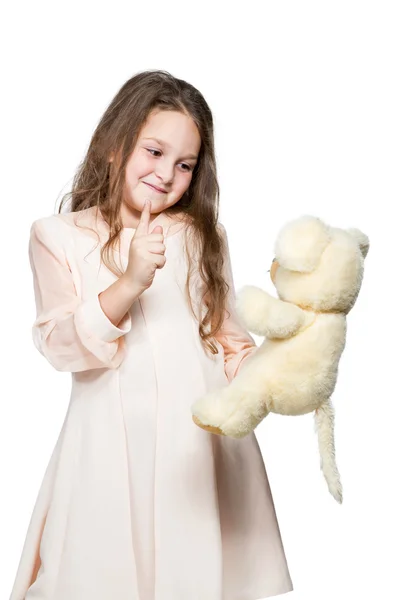 Girl playing with a toy teddy bear — Stock Photo, Image