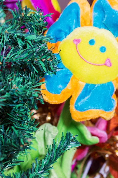 Artificial spruce and toy flower — Stock Photo, Image