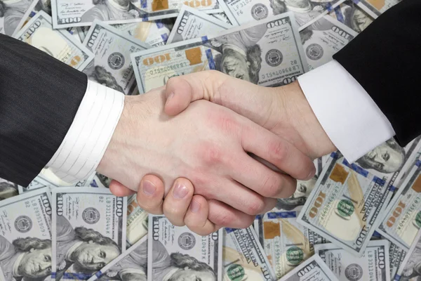 Business handshake on the background of money — Stock Photo, Image