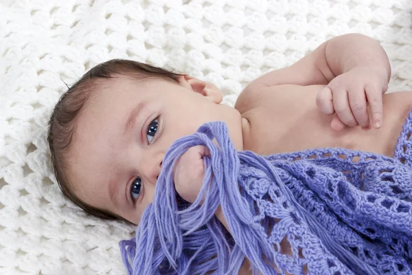 Naked baby covered with knit a scarf — Stock Photo, Image