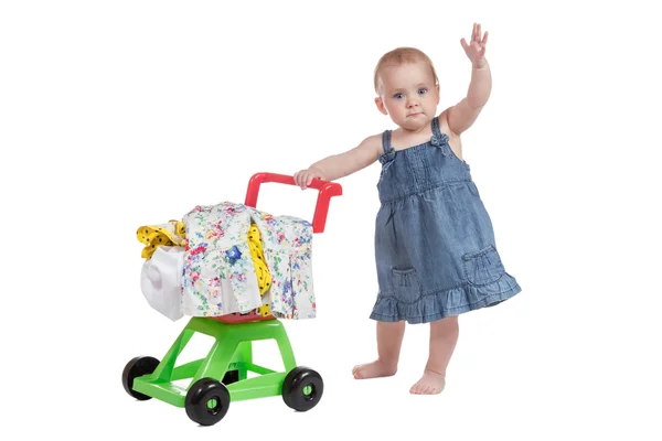 Shopping cart full of clothes and baby — Stock Photo, Image