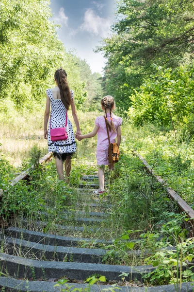 Two girls go by railway — Stock Photo, Image