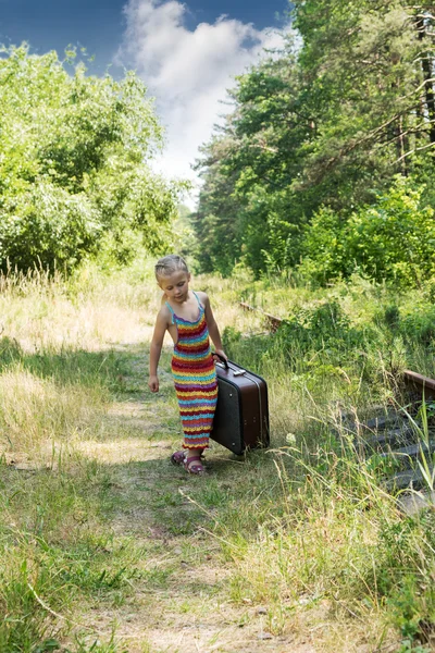 Little girl with a suitcase at the railway — Stock Photo, Image