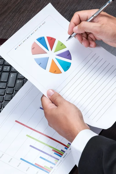 Businessman studying charts — Stock Photo, Image