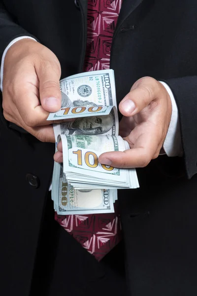 Businessman counts dollars — Stock Photo, Image