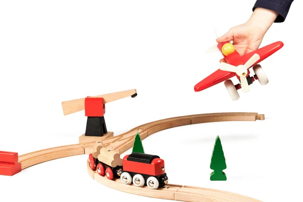 Child plays with wooden airplane — Stock Photo, Image