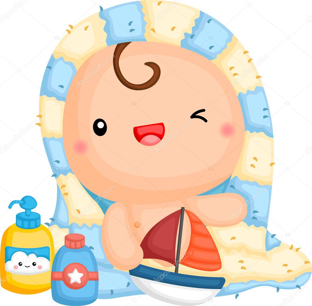 a baby wrapped in a towel holding a toy