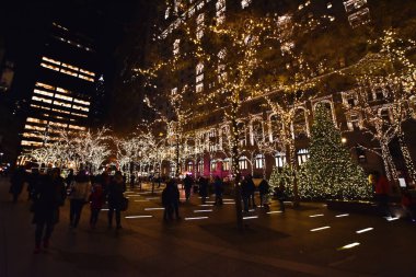 New York, USA, November 30, 2019. Christmas lights in Zuccotti Park formerly Liberty Plaza Park near World Trade Centers Memorial in financial district of Lower Manhattan, NY. clipart