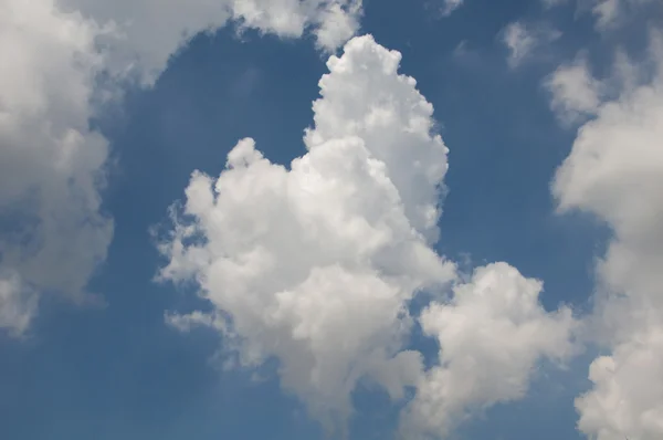 Heart shaped clouds on blue sky.
