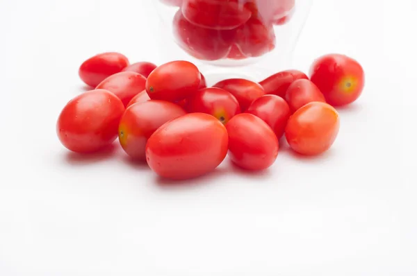 Small red tomatoes on water glass. — Stock Photo, Image