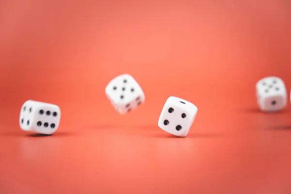 dice in flight on a red background. throw for luck. chance