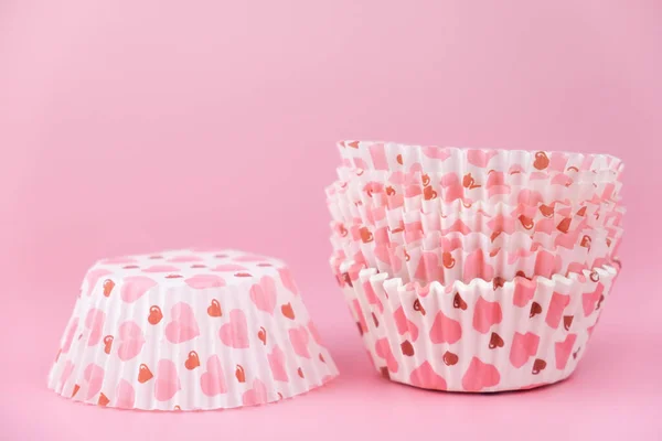 Pembe arka planda kalpleri olan boş pembe kek kalıbı. Sevgililer Günü