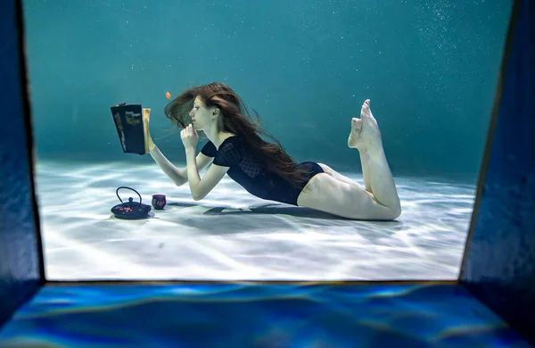 Beautiful Girl Red Swimsuit Reads Interesting Book Underwater Blue Background — Stock Photo, Image