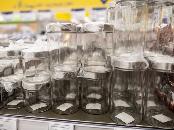 household items of daily use are placed on shelves and hang on holders in a large store