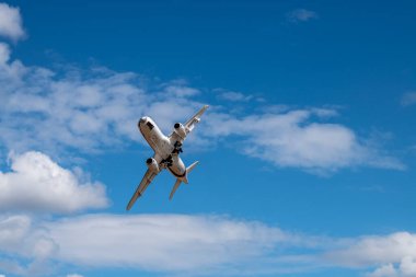 a white passenger plane makes sharp turns near the airfield