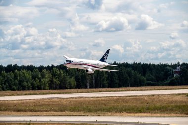 a white passenger plane makes sharp turns near the airfield