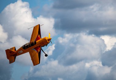 beautiful plane makes a difficult turn leaves a white trail of flight against the background of the sky