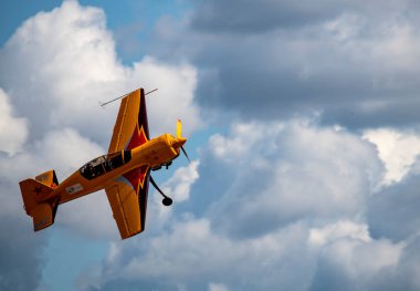 beautiful plane makes a difficult turn leaves a white trail of flight against the background of the sky