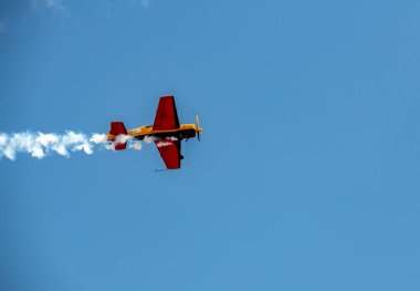 beautiful plane makes a difficult turn leaves a white trail of flight against the background of the sky