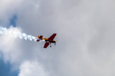beautiful plane makes a difficult turn leaves a white trail of flight against the background of the sky