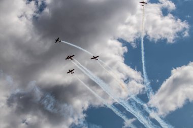 beautiful plane makes a difficult turn leaves a white trail of flight against the background of the sky