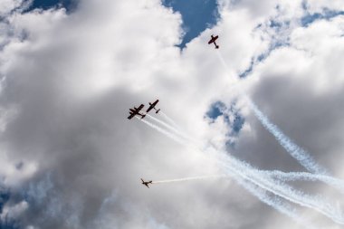 beautiful plane makes a difficult turn leaves a white trail of flight against the background of the sky