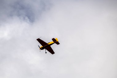 beautiful plane makes a difficult turn leaves a white trail of flight against the background of the sky