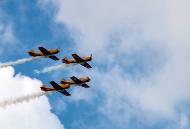 beautiful plane makes a difficult turn leaves a white trail of flight against the background of the sky