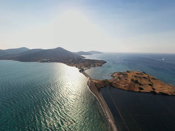 panoramic view of the old stone mills, bridge, road and sea filmed from a drone