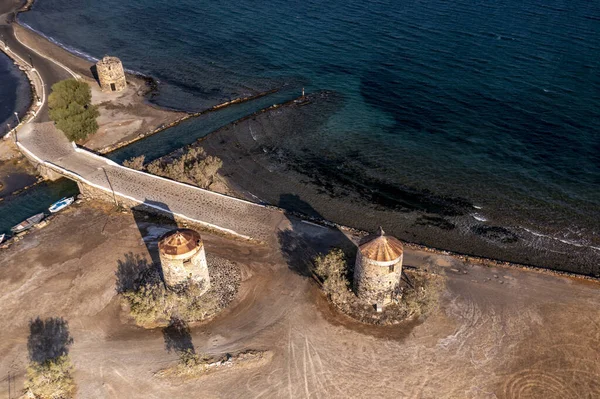 panoramic view of the old stone mills, bridge, road and sea filmed from a drone