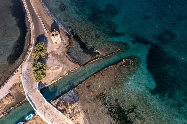 panoramic view of the old stone mills, bridge, road and sea filmed from a drone