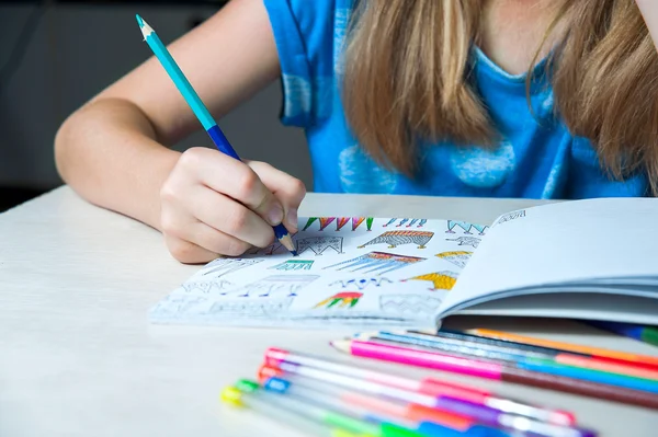 Criança pintando um livro de colorir. Nova tendência para aliviar o stress . — Fotografia de Stock