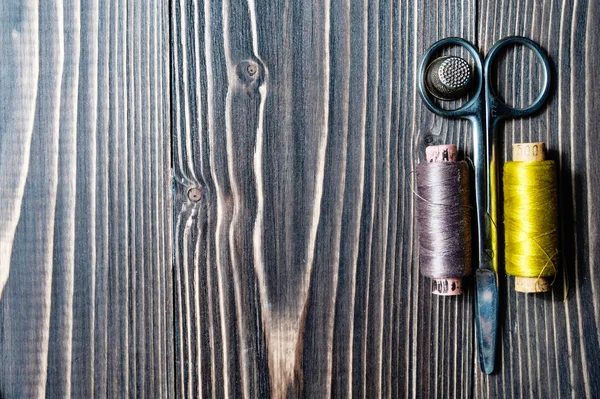 Acessórios para costura em mesa de madeira escura — Fotografia de Stock