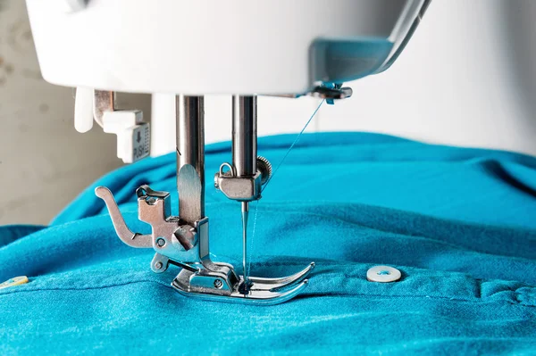 Closeup of sewing machine with blue cloth — Stock Photo, Image