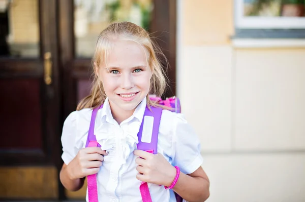 Happy little schoolgirl portrait near school — Stock Photo, Image