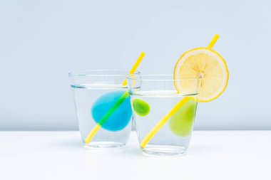 Bardağa iki sağlıklı limonata konur. İki temiz bardakta saf su..