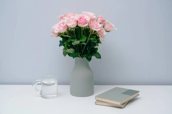 Pink roses in a desk vase