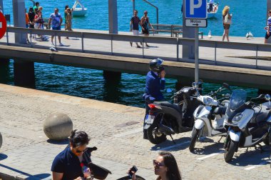 22 Haziran 2016 'da Barcelona, İspanya' da öğle yemeği saatinde motosiklet sürdükten sonra Barcelona iskelesine park eden ofis çalışanı..  